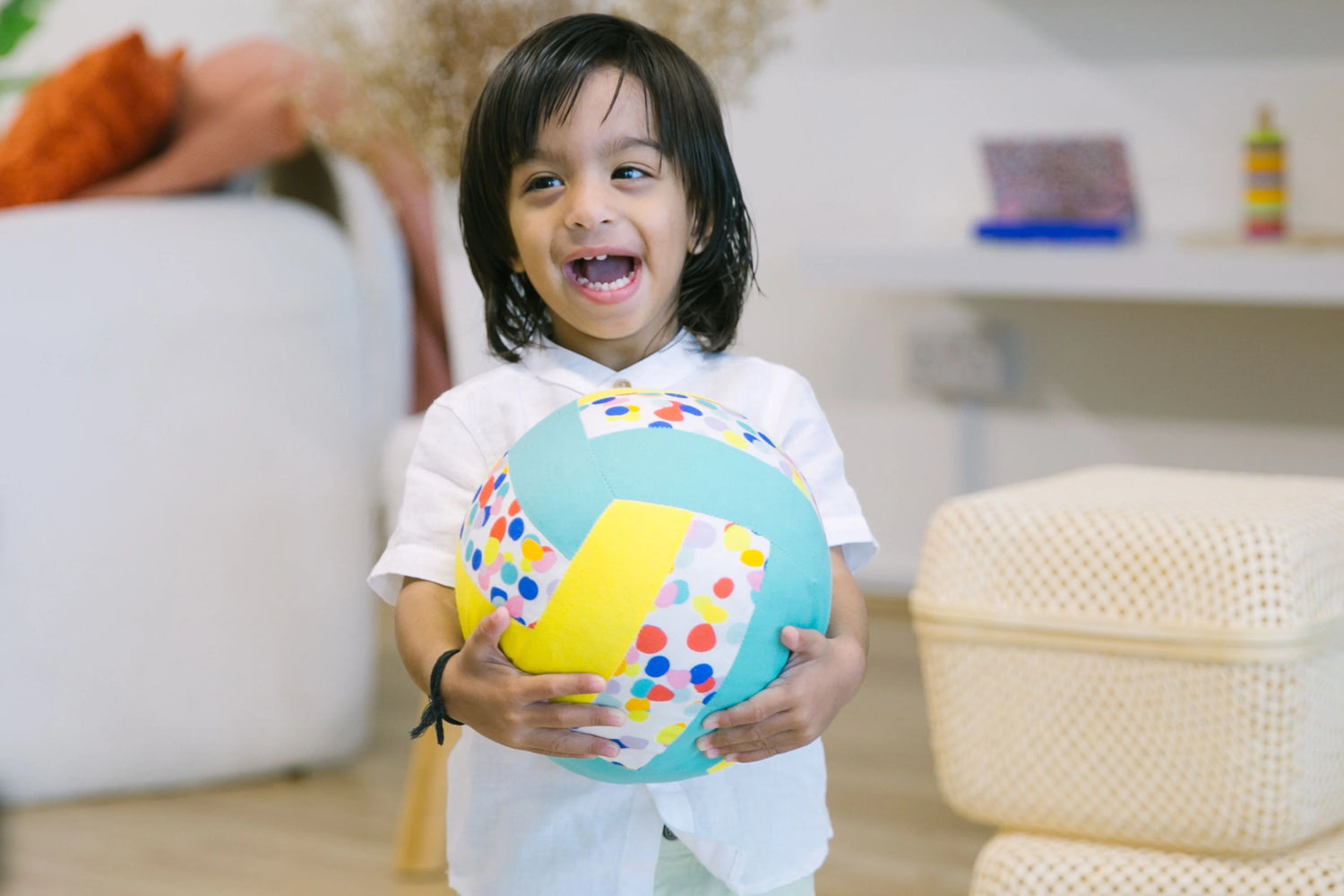 toddler smiling with toddler art on taped down paper