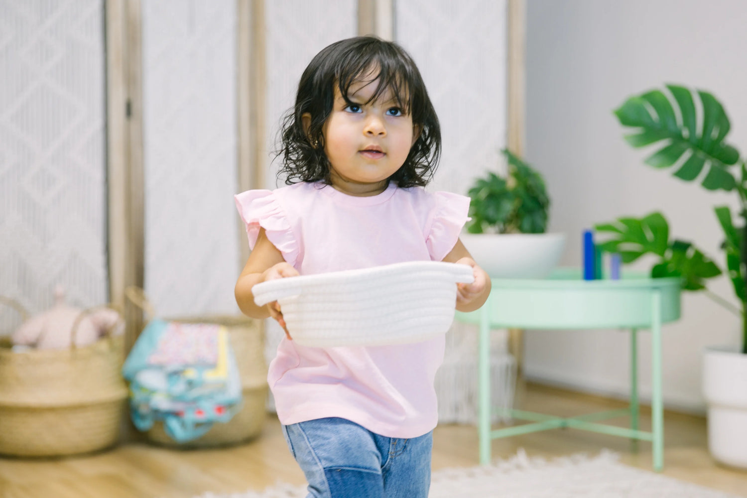 A toddler carrying a doll, demonstrating their sense of comfort and developing motor skills through carrying objects.