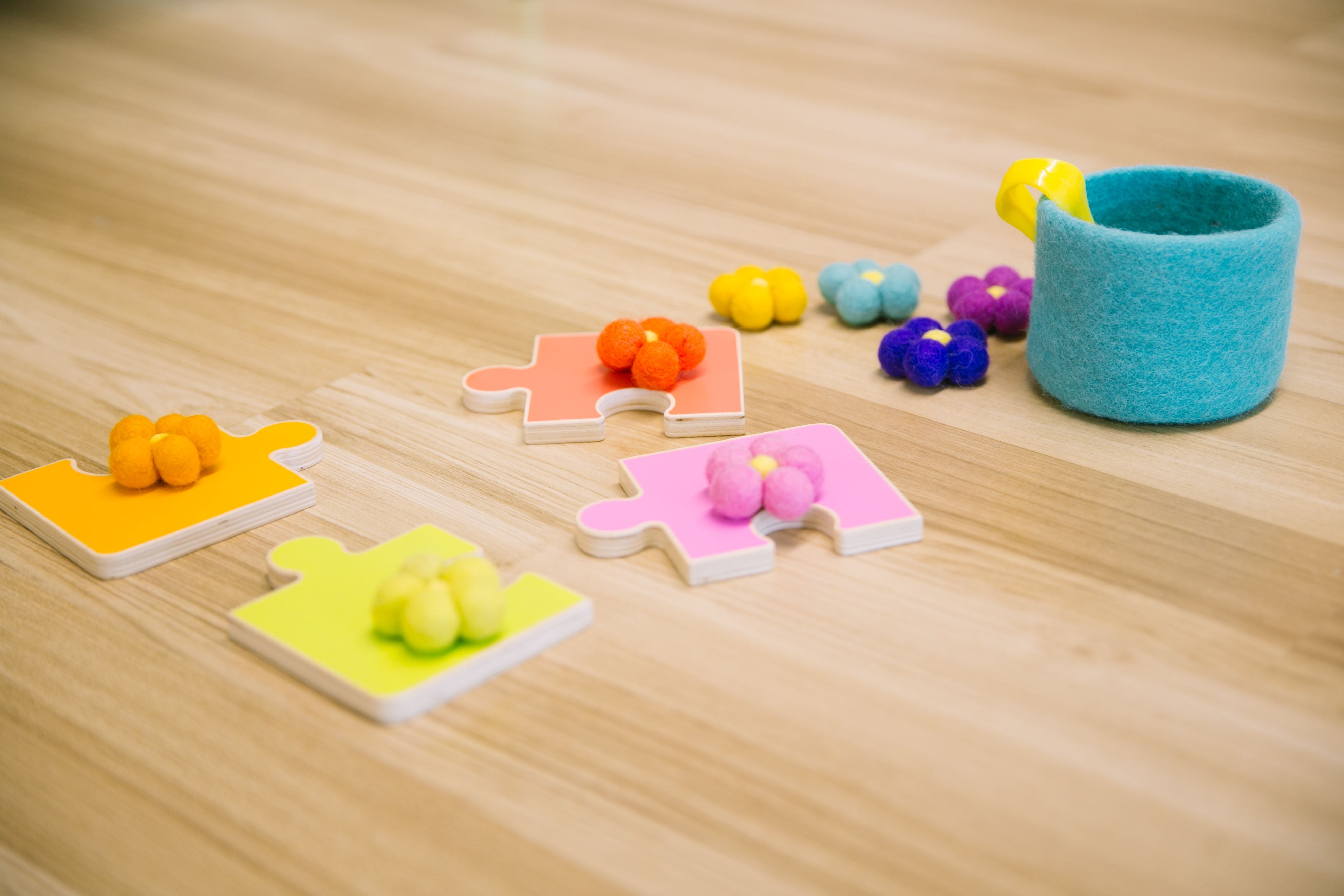 Sensory flowers on top of puzzle pieces, matching colors.