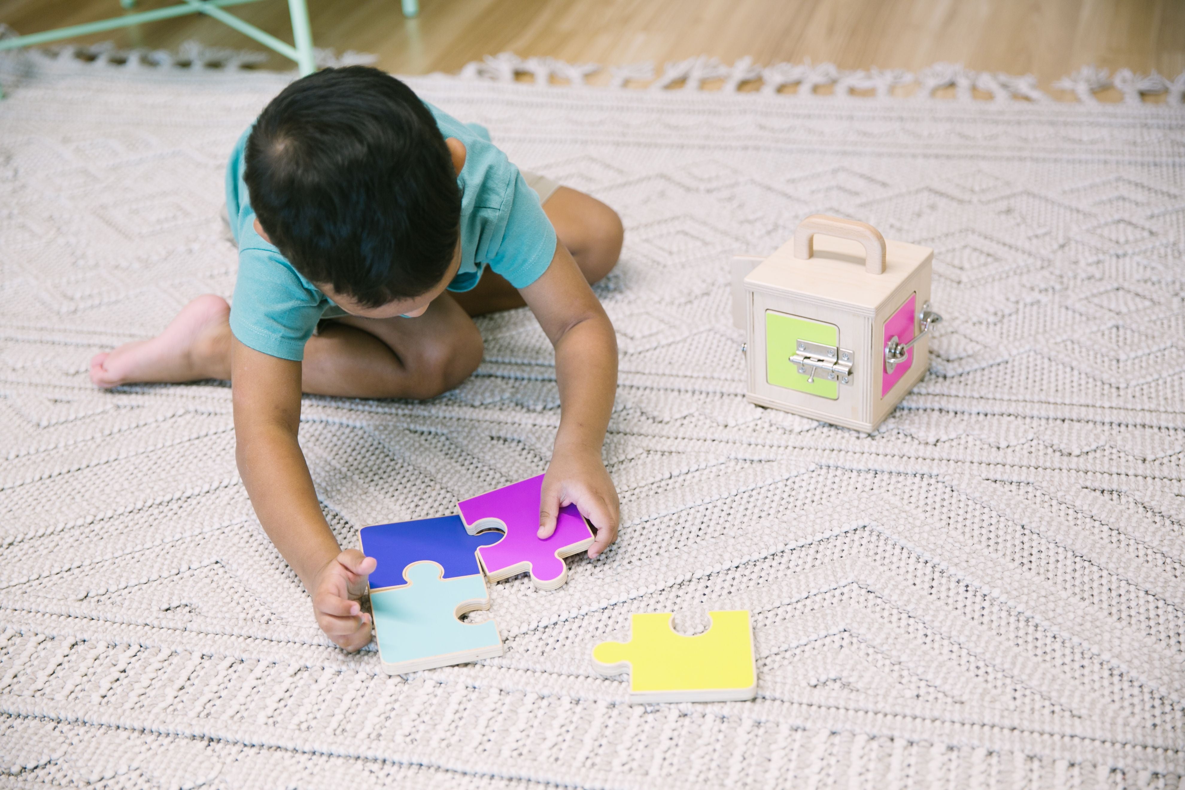 toddler putting puzzle pieces together by himself as part of early learning from error